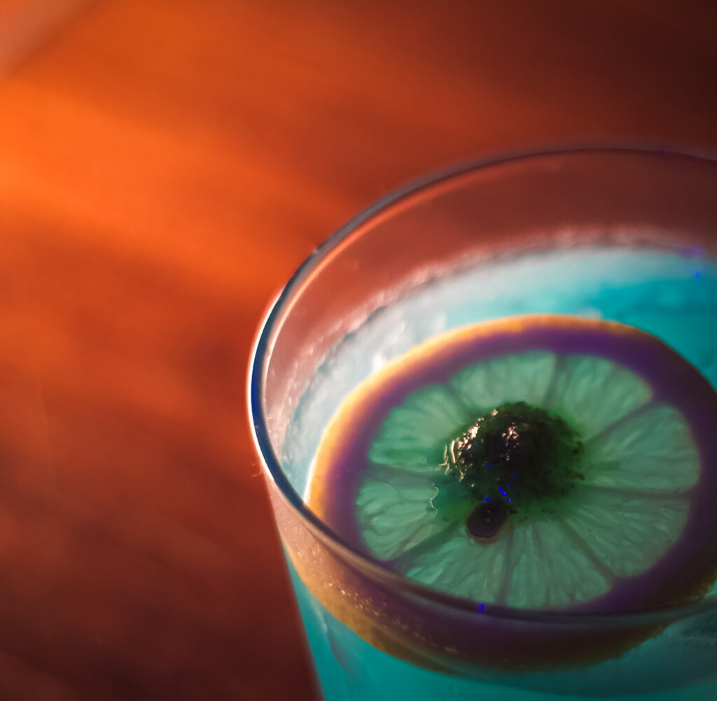 IMG_1345 A vibrant blue cocktail with a lime slice garnish at the Craft Cocktail Play It Cool Pop-Up Bar Event.